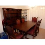 An extending dining table with four dining chairs and two carvers with upholstered seats,