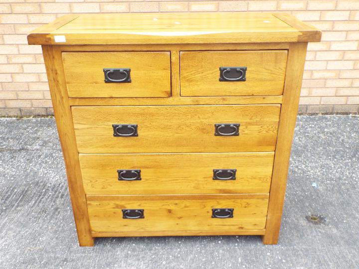 An oak chest of two over three drawers m