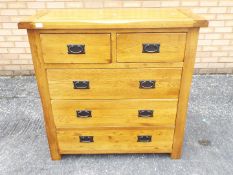 An oak chest of two over three drawers m