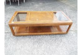 A coffee table with glass panel top, app