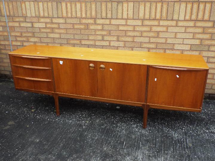 A H McIntosh - A mid century teak sideboard having central twin door cupboard flanked to one side - Image 2 of 5