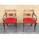 A pair of mahogany armchairs with inlaid decoration.