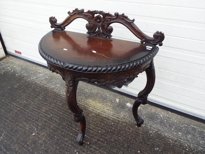 A demi lune console table with carved decoration on tripod supports, - Image 2 of 3