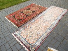 A carpet and runner, largest approximately 297 cm x 97 cm.