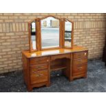 A kneehole dressing table with triptych mirror and six drawers,
