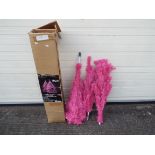 An unlit 6 foot pink Christmas tree. Please note the picture is an example of the tree decorated.