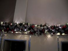 A double nine foot illuminated green garland with ice white lights and plug.