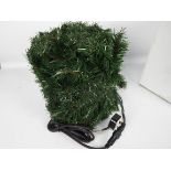 A bag containing several assorted lengths of unlit green garlands.