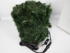 A bag containing several assorted lengths of unlit green garlands.