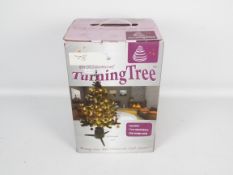 A revolving Christmas tree stand produce