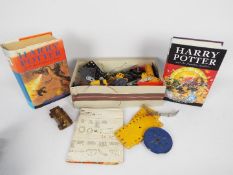 A quantity of vintage Meccano and two hardback Harry Potter first editions.