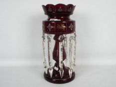 A Victorian ruby glass lustre with clear glass drops, approximately 35 cm (h).