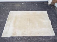 A Chinese wool carpet measuring approximately 182 cm x 120 cm