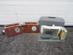 Two vintage style Bush portable radios and a cased Necchi Supernova sewing machine.