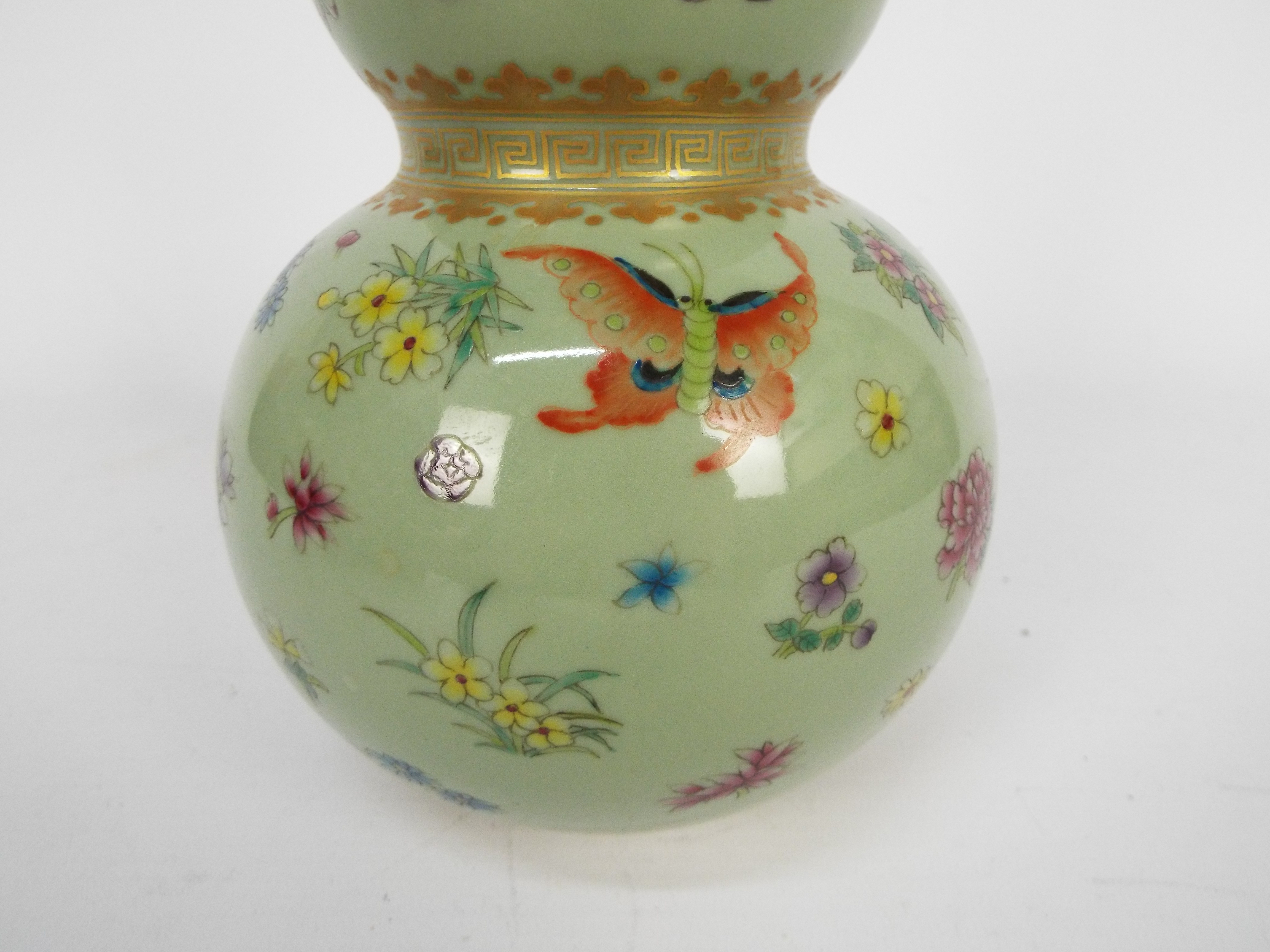 A Chinese double gourd vase decorated with flowers and butterflies against a green ground, - Image 14 of 18