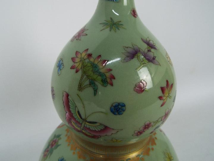 A Chinese double gourd vase decorated with flowers and butterflies against a green ground, - Image 5 of 18