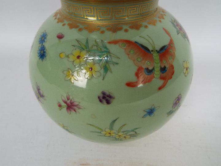 A Chinese double gourd vase decorated with flowers and butterflies against a green ground, - Image 2 of 18
