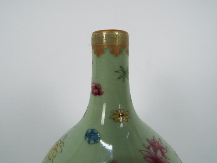 A Chinese double gourd vase decorated with flowers and butterflies against a green ground, - Image 7 of 18