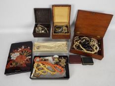 A collection of costume jewellery to include necklaces, brooches, bracelet and similar.