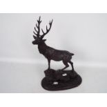 A bronzed metal model of a stag stood atop a rocky outcrop, after Pierre Jules Mene, signed,