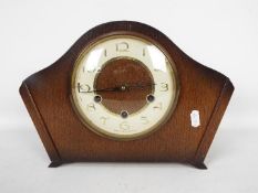 An oak cased Smiths mantel clock with key and pendulum.