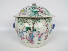A Chinese famille rose bowl and cover, decorated with figures in a garden setting,