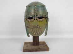Studio pottery model of an Anglo Saxon helmet on wooden stand,