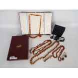 A graduated amber bead necklace, contained in presentation box, approximately 66 cm (l),