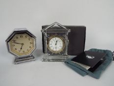 An octagonal, chrome cased desk clock, 12 cm (h) and a boxed Waterford Crystal Acropolis clock.