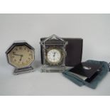 An octagonal, chrome cased desk clock, 12 cm (h) and a boxed Waterford Crystal Acropolis clock.