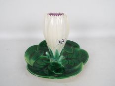 A Victorian majolica centrepiece formed as a waterlily with central flower and three surrounding