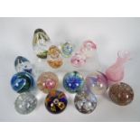 A varied collection of paperweights including Caithness and a Caithness vase.