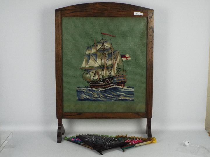 A vintage, oak framed, needlework fire screen,