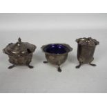 A George V three piece condiment set comprising mustard pot with blue glass liner,