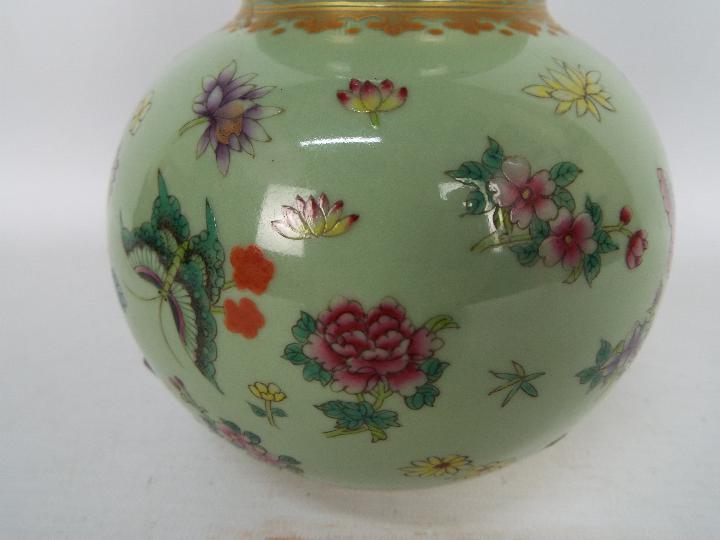 A Chinese double gourd vase decorated with flowers and butterflies against a green ground, - Image 4 of 18