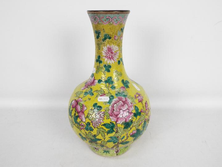 A vase decorated with chrysanthemum against a yellow ground,