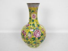 A vase decorated with chrysanthemum against a yellow ground,