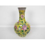 A vase decorated with chrysanthemum against a yellow ground,