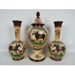 A garniture of three hand painted glass vases comprising ovoid pedestal vase with cover,