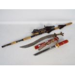Two decorative replica swords one in the form of a Wakizashi and the other in the form of an