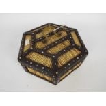 A vintage porcupine quill work box of hexagonal section with inlaid decoration and brass handle,