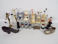 A good collection of various hat pin stands to include ceramic, glass, ebony, brass and similar,