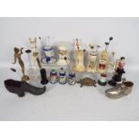 A good collection of various hat pin stands to include ceramic, glass, ebony, brass and similar,
