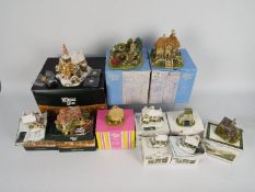 A collection of boxed Lilliput Lane models,