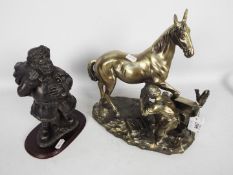 A cold cast bronze from the Leonardo Collection depicting Santa Claus and one other of a farrier at