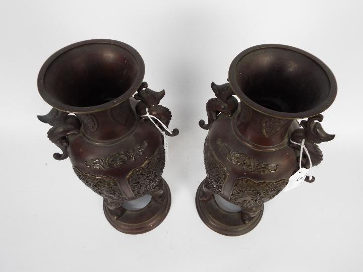 A pair of cast metal vases with twin chilong handles, cast decorative panels, - Image 5 of 5