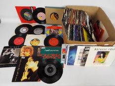 A collection of 7" vinyl records to include Duran Duran, David Bowie, Pet Shop Boys, Queen,