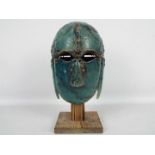 Studio pottery model of an Anglo Saxon helmet on wooden stand,