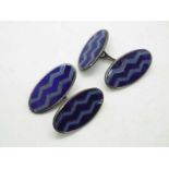 A gentleman's pair of silver cufflinks of oval form with blue enamel decoration