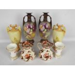 A pair of twin handled vases with floral decoration, a pair of tapered vases with floral decoration,